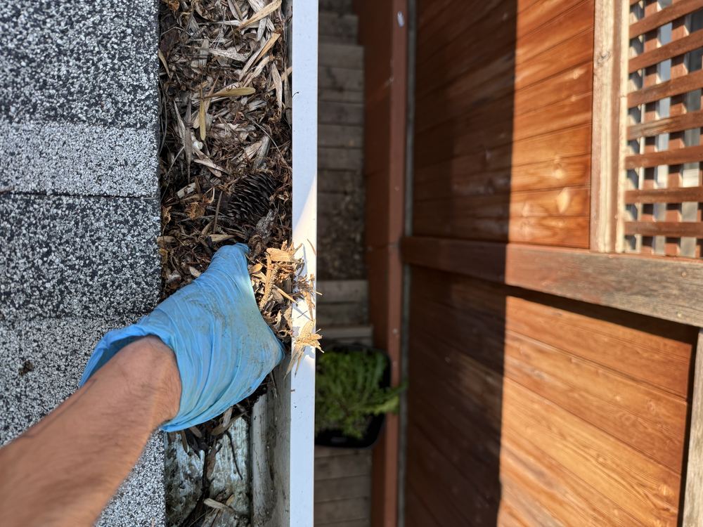 Kobo tech pulling debris from a gutter
